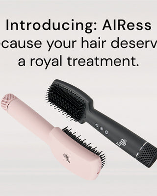 Two Airess tools on a neutral background. A blush AIress lays upside down in a vertical position and the Black Airess lays in an upward position parallel to the blush Airess.