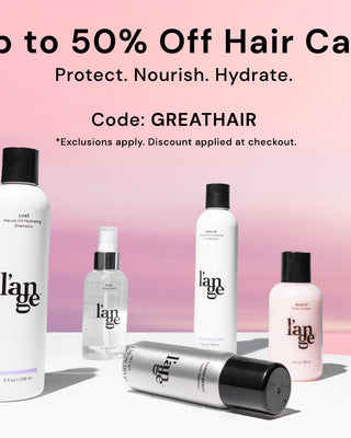 Promotional display for hair care products with a pink gradient background, highlighting a discount of up to 50% using the code "GREATHAIR".