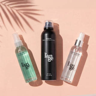 L'ange hair care (Salt & Sea, Hold-All. and Thermla Magique), arranged on a peach background with palm leaf shadow