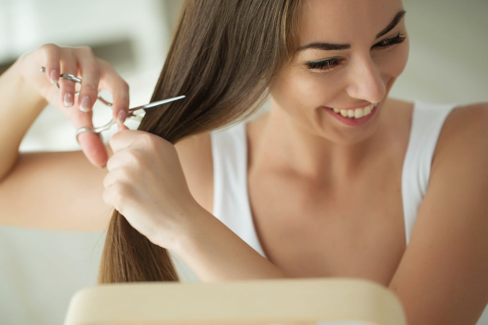 girl cutting her own hair