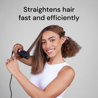A person with medium-length hair smiles while using a hair straightener, with text above stating, "Straightens hair fast and efficiently."