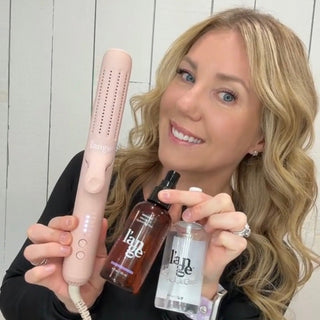 Smiling woman showcasing a pink hair tool alongside two bottles of hair products, all branded with "l'ange".