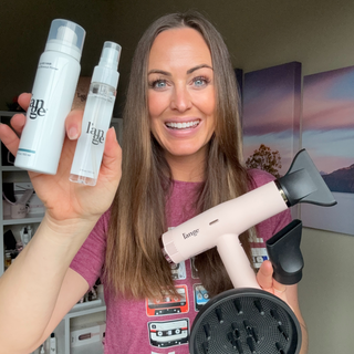 Smiling individual showcasing hair care products and a styling tool, featuring a blow dryer with attachments and sleek design.