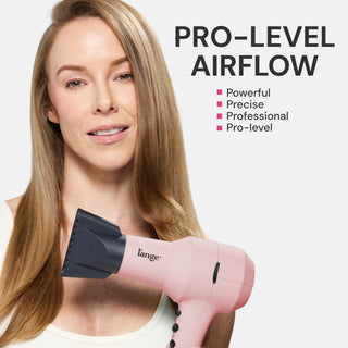 Woman with long straight blonde hair holding a pink L'ange dryer with concentrator nozzle near her face, with text "PRO-LEVEL AIRFLOW" and bullet points "Powerful," "Precise," "Professional," "Pro-level."