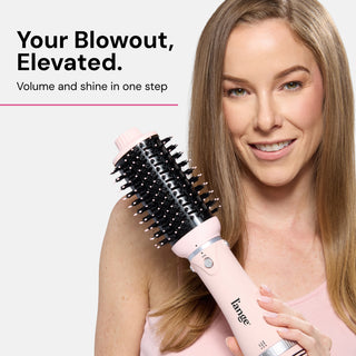 Woman holding a pink hair styling tool with bristles, accompanied by text promoting a product that delivers volume and shine in one step.