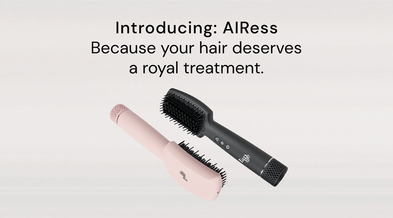 Two Airess tools on a neutral background. A blush AIress lays upside down in a vertical position and the Black Airess lays in an upward position parallel to the blush Airess.