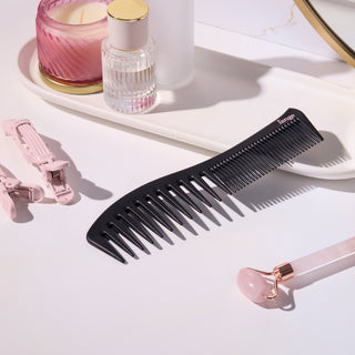 Black dual ended comb on a vanity tray 