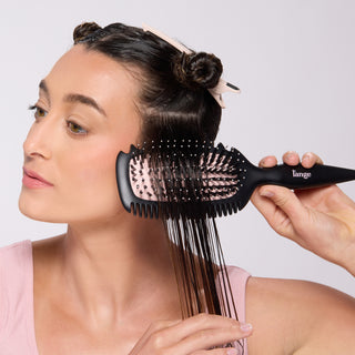 model detangling wet hair with the Curl Sculptor brush