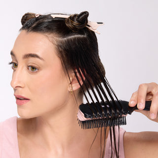 model brushing through wet hair with the CustomCurl L’ange brush
