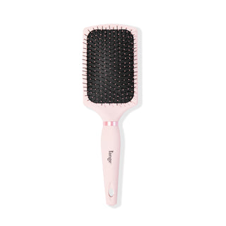 A blush-colored paddle brush stands vertically so you see the nylon bristles & soft-touch handle.