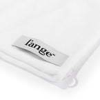 The corner securing loop with the logo is displayed on the white microfiber towel.