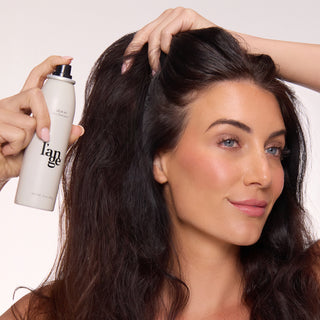 Model holding and using Deja Vu Dry Shampoo on her scalp