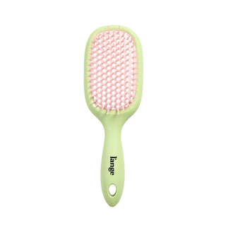 green and pink L’ange detangling brush on white background