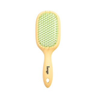 yellow and green L’ange detangling brush on white background