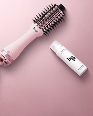 Value Set. L’ange hair products laid flat on a pink background including Le Volume 60mm (Blush) and glass hair