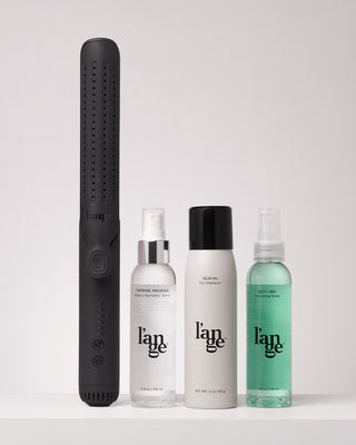 Value Set. L’ange hair products standing up on a grey background including Le Duo (Black - grande) , thermal magique, deja vu, salt +sea