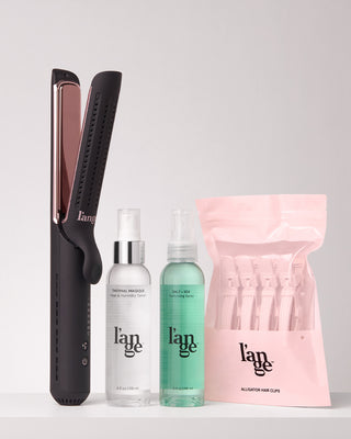 Value Set. L’ange hair products standing up on a grey background including Le Duo  Edge (black) , thermal magique, salt + sea, and alligator hair clips