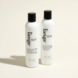L'ange Frizz Care Shampoo and Conditioner bottles on a beige background