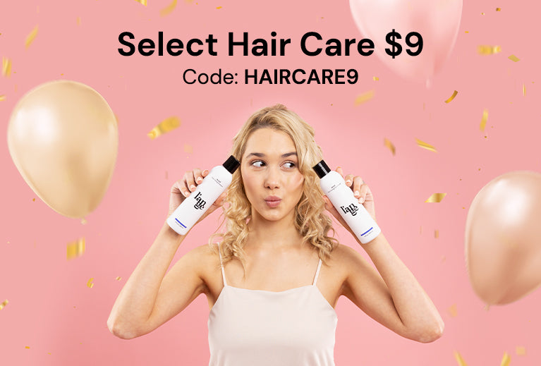 Woman holding two hair care bottles against a pink background with balloons and confetti, promoting a $9 hair care sale with the code HAIRCARE9.