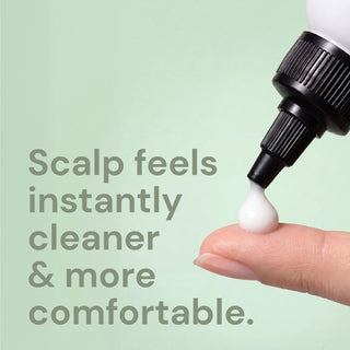 Dropper releasing a drop of cleanser onto a fingertip, with text "Scalp feels instantly cleaners & more comfortable"