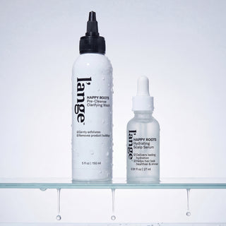 L'ange Happy Roots Pre-Cleanse Clarifying Wash and Hydrating Scalp Serum on wet glass shelf with water droplets