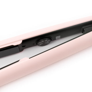 Zoomed in view of blush flat iron and black plates and round temperature settings