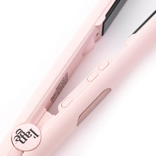 Zoomed in view of blush flat iron with temperature button and ON/OFF buttons with black L’ange logo