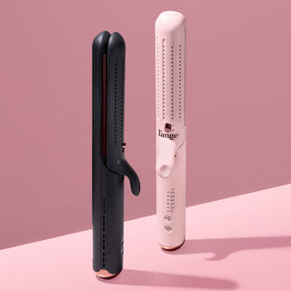 Black and white hair styling tools against a pink background, featuring temperature settings and ergonomic handles.