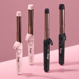 Four sleek curling irons featuring a combination of pink and black handles with rose gold barrels, displayed on a pink background.