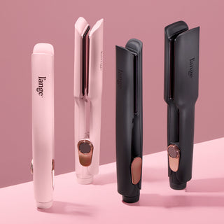 Four L’ange Le Titane flat irons displayed vertically on a pink surface, showing both blush pink and matte black colorways with rose gold accents, highlighting the product’s premium design.