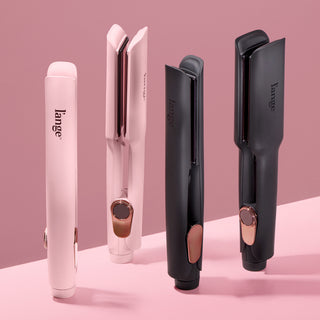 Four L’ange Le Titane flat irons displayed vertically on a pink surface, showing both blush pink and matte black colorways with rose gold accents, highlighting the product’s premium design.