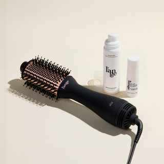 The Fresh Blowout Trio Value Set featuring a Black 60mm Le Volume,  Glass Hair, and Sky Lift, displayed on a beige background.