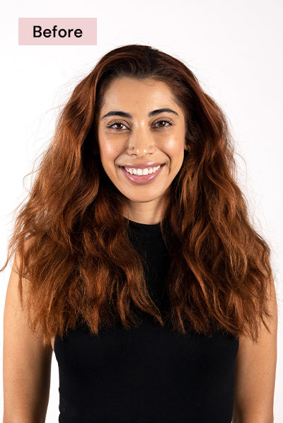 Smiling woman with long, wavy auburn hair wearing a black sleeveless top, labeled "Before".