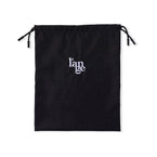 The large black hair tool bag is laid out flat so you can see the logo and drawstrings. 