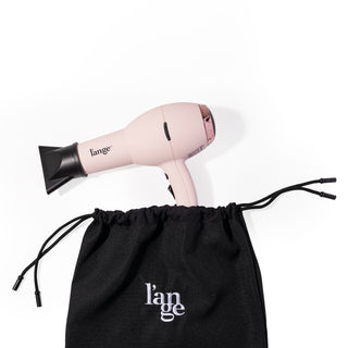 A pink hair dryer sticks out the top of the tool bag showing how large of a tool you can fit inside.