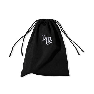 The drawstrings of the black hair tool bag are pulled tight to show the bag closed.