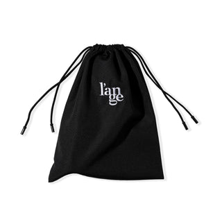 The drawstrings of the black hair tool bag are pulled tight to show the bag closed.