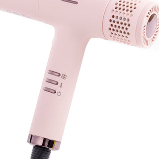 Zoomed in view of blush hair dryer handle with speed, temperature and power buttons