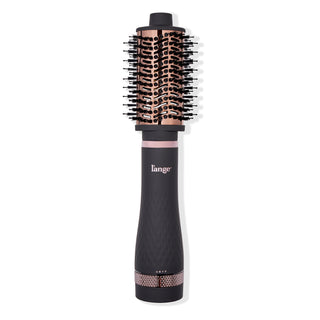 A black and rose gold round brush hair dryer with a textured handle and bristle-covered barrel.