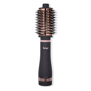 A black and rose gold round brush hair dryer with a textured handle and bristle-covered barrel.