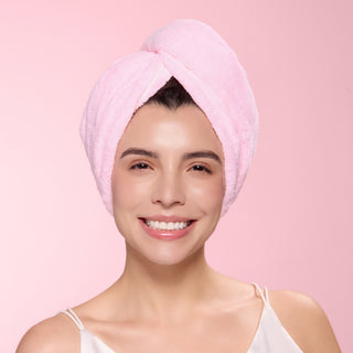 Woman with blush hair wrap towel around her head