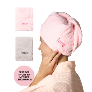 Model wearing a pink L’ange hair wrap towel; folded pink and gray towels shown; badge reads “BEST FOR SHORT TO MEDIUM LENGTH HAIR.”