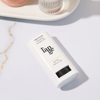 Smoothing Pomade Stick placed on a marble surface 