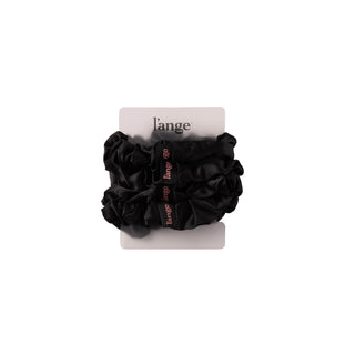 L’ange large satin scrunchies 4-piece set in black, stacked on a card against a white background.