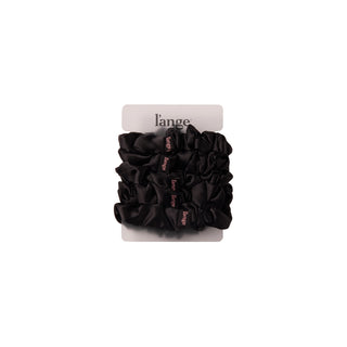 L’ange medium satin scrunchies 5-piece set in black, stacked on a card against a white background.