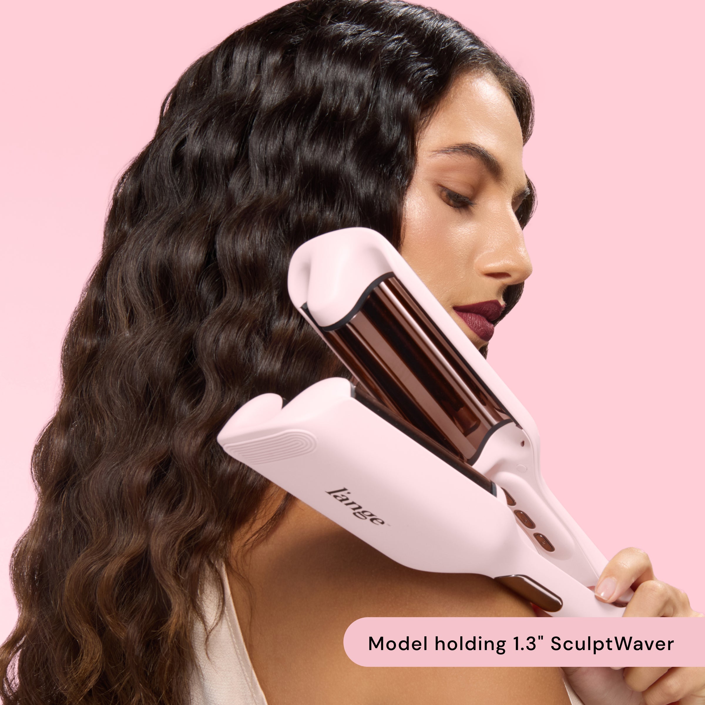 woman holding waver while showcasing her wavy hair. Text reads: "model holding 1.3" SculptWaver"