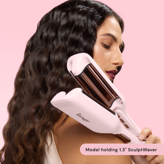 woman holding waver while showcasing her wavy hair. Text reads: "model holding 1.3" SculptWaver"