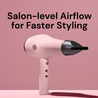 L’ange Soleil hair dryer in blush pink displayed with concentrator attachment against a pink background. Text above reads: ‘Salon-level Airflow for Faster Styling,’ emphasizing the professional performance.