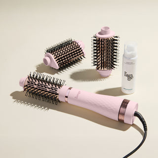 The Switch It Up Value Set, featuring a Blush Multi-Volume Series Brush, 65mm and secondary attachments, and Glass Hair, displayed on a beige background