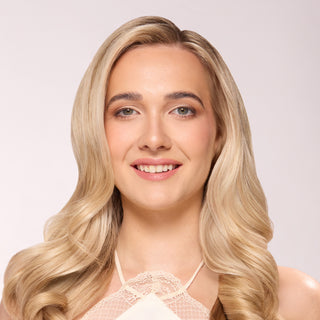 model with voluminous, smooth curls after using thermal rollers